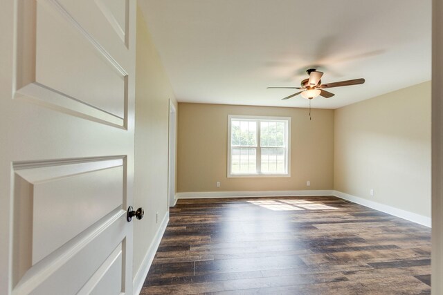 10890 Minor Hill Hwy, Goodspring, TN 38460 - unfurnished room featuring a ceiling fan, dark wood finished floors, and baseboards