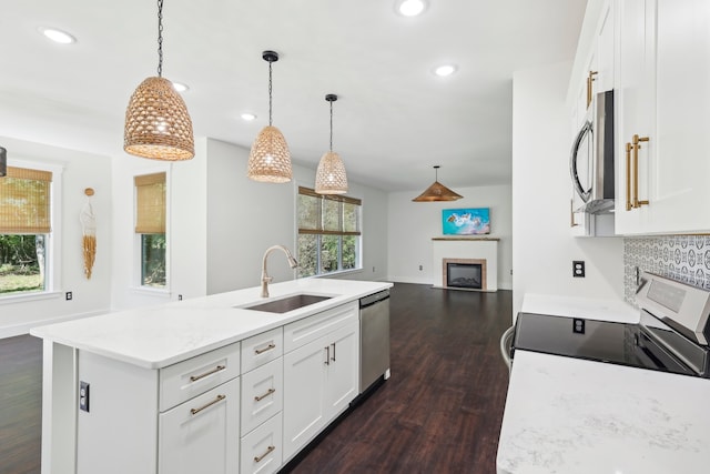 kitchen with white cabinets, stainless steel appliances, plenty of natural light, and sink