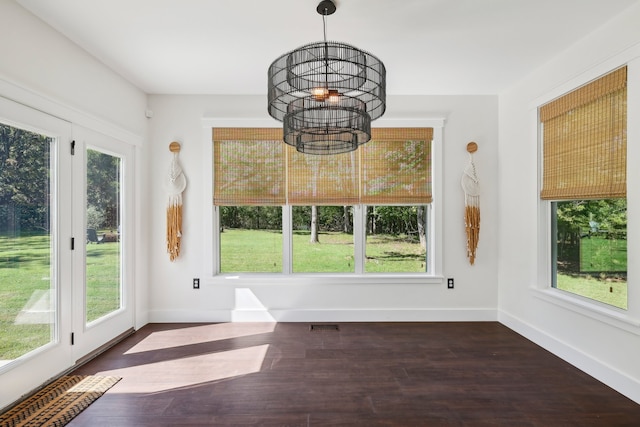 unfurnished sunroom with an inviting chandelier