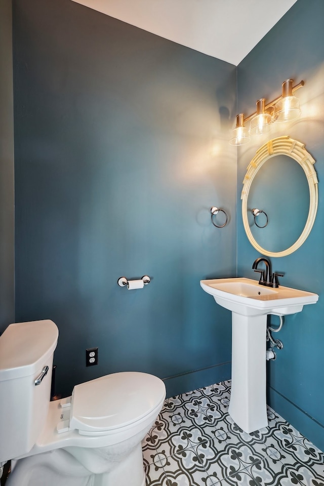 bathroom featuring tile patterned flooring and toilet