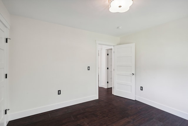 unfurnished room featuring dark hardwood / wood-style flooring