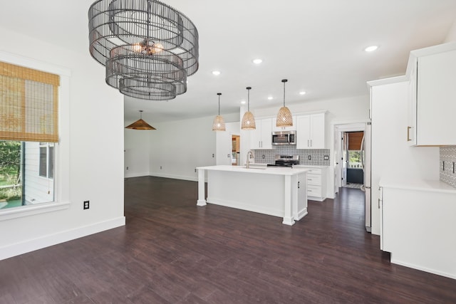 kitchen featuring stainless steel appliances, plenty of natural light, and dark wood-type flooring