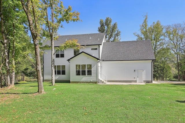 back of house with a lawn