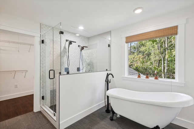 bathroom with hardwood / wood-style flooring and independent shower and bath