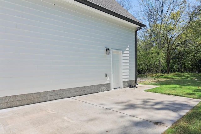 view of home's exterior with a yard and a patio area