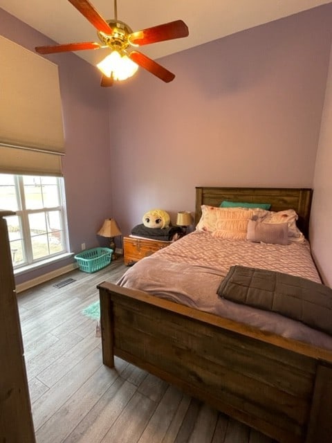 bedroom featuring ceiling fan and light hardwood / wood-style flooring