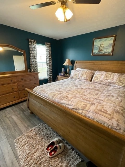 bedroom with light wood-type flooring and ceiling fan