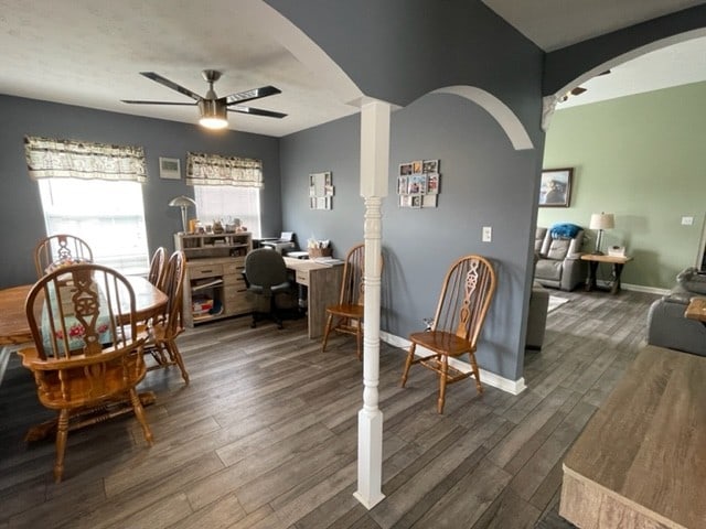 dining space featuring ceiling fan and dark hardwood / wood-style floors