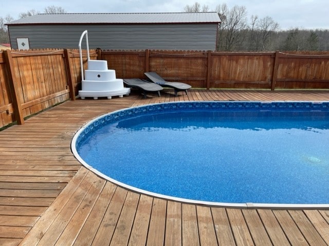 view of swimming pool featuring a wooden deck