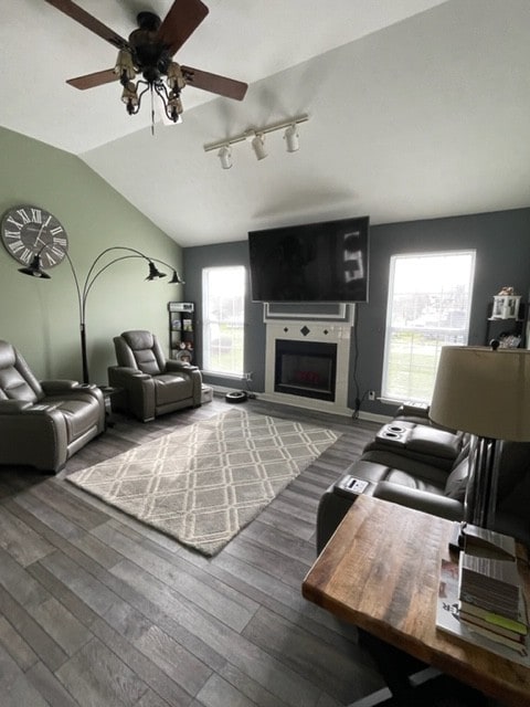 living room featuring dark hardwood / wood-style floors, ceiling fan, a healthy amount of sunlight, and lofted ceiling