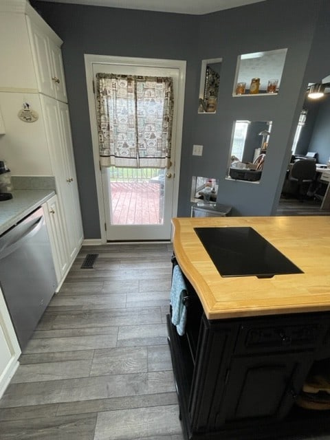 kitchen with dishwasher, white cabinets, and light hardwood / wood-style floors