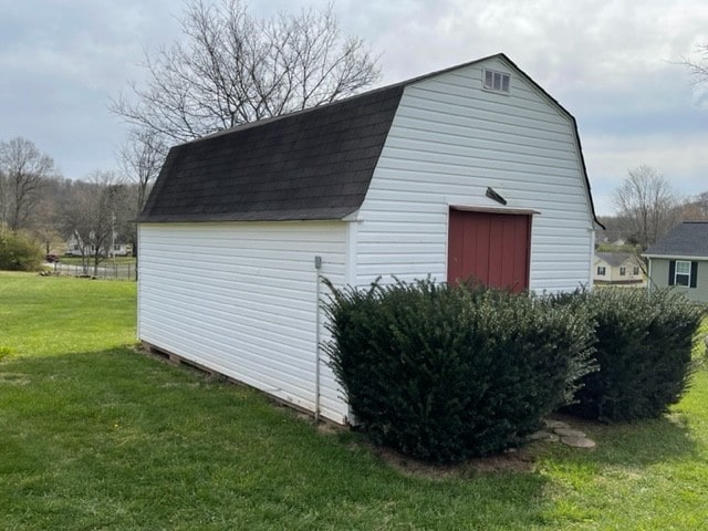 view of outbuilding with a lawn