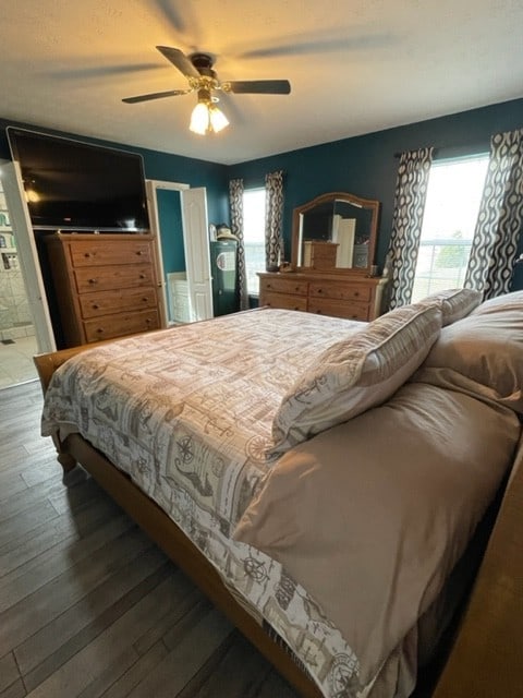 bedroom with ceiling fan and dark hardwood / wood-style flooring