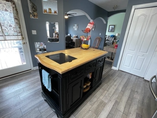 kitchen with a center island, light hardwood / wood-style floors, and ceiling fan