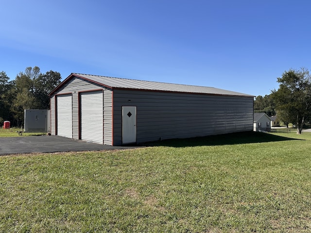 garage featuring a lawn