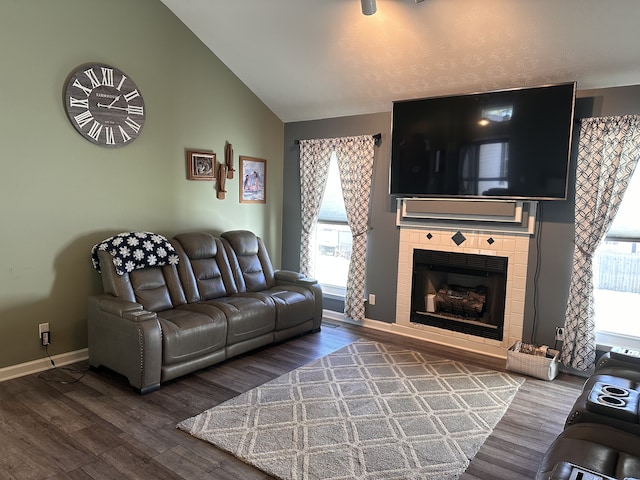 living room with hardwood / wood-style flooring, a wealth of natural light, and lofted ceiling