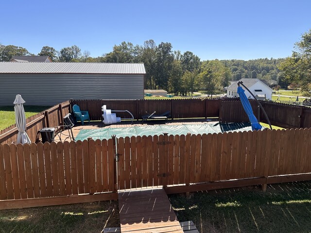 deck featuring a covered pool