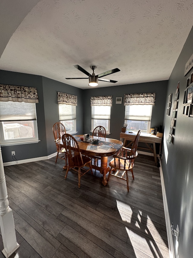 dining space with a wealth of natural light, dark hardwood / wood-style flooring, ceiling fan, and a textured ceiling