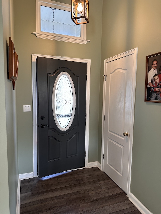 entrance foyer featuring dark wood-type flooring and a high ceiling