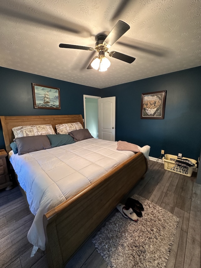 bedroom featuring ceiling fan, hardwood / wood-style floors, and a textured ceiling