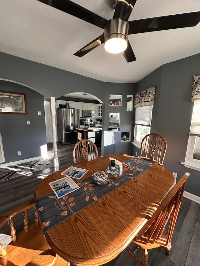 dining space featuring ceiling fan and dark wood-type flooring