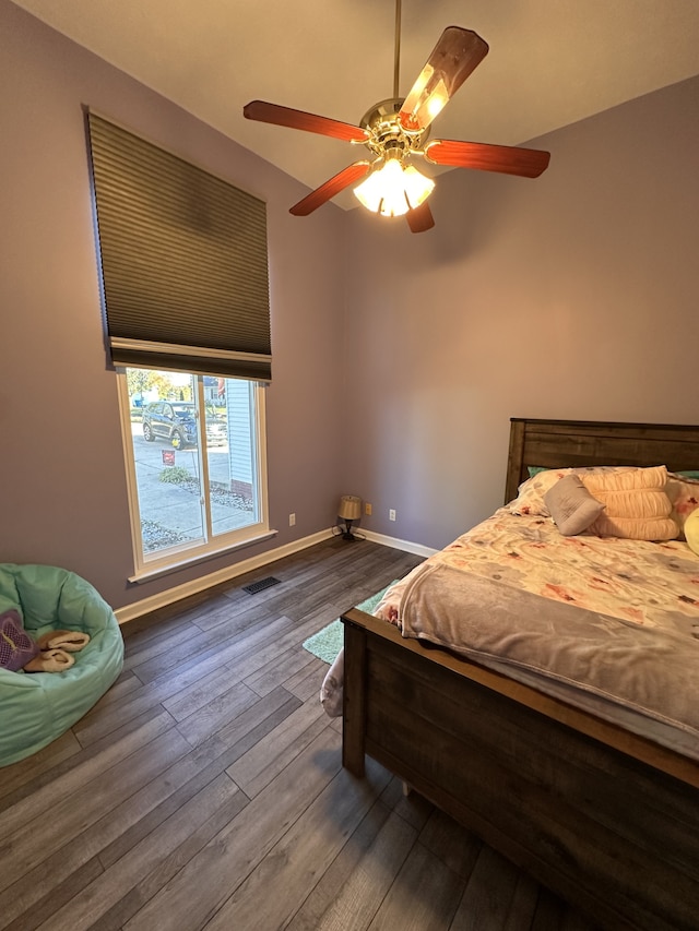 bedroom with dark hardwood / wood-style floors and ceiling fan