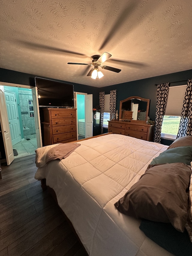 bedroom with hardwood / wood-style floors, ceiling fan, a textured ceiling, and connected bathroom