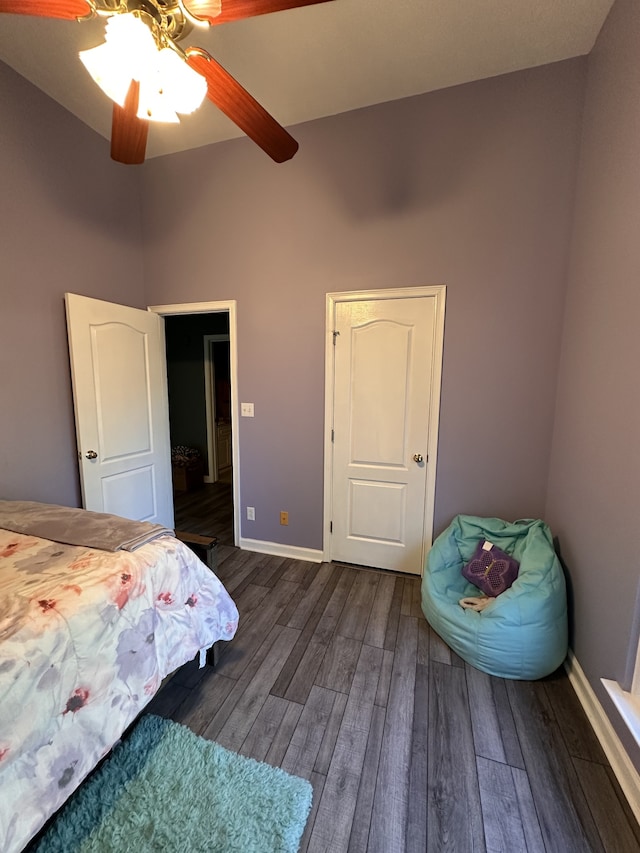 bedroom with ceiling fan and dark hardwood / wood-style flooring