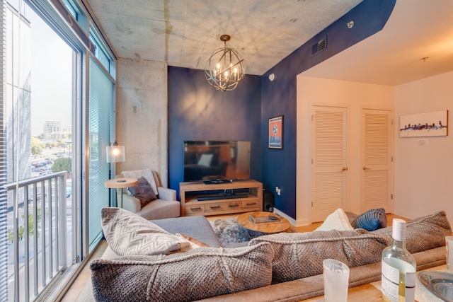 living room featuring a notable chandelier, a wealth of natural light, and hardwood / wood-style floors