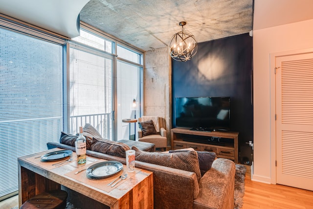 living room featuring a chandelier and light wood-type flooring