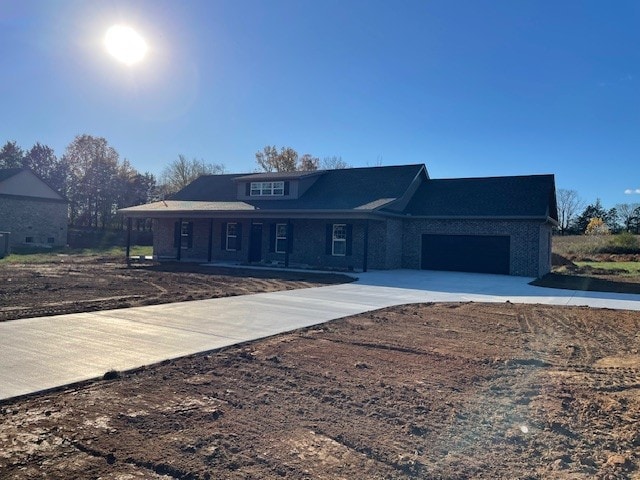 view of front of house featuring covered porch and a garage