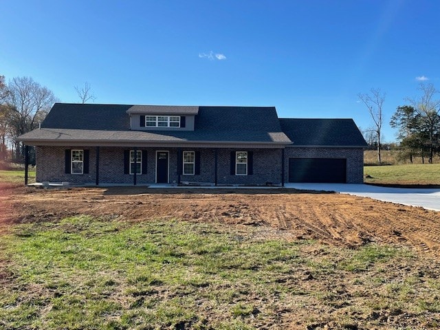 view of front of home with covered porch and a garage