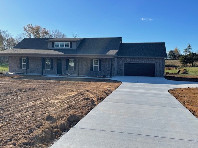 view of front of home with covered porch and a garage