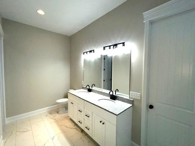 bathroom featuring vanity and toilet