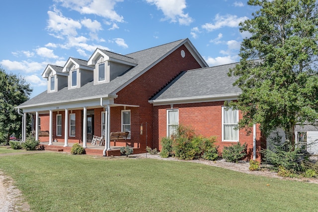 view of front of home featuring a front lawn and covered porch