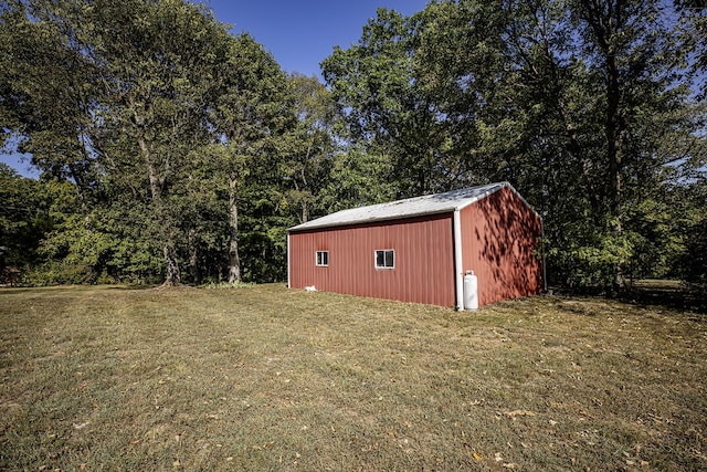 view of outbuilding with a yard