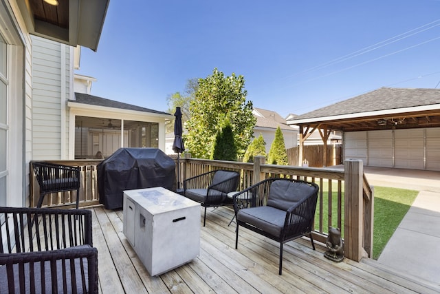 deck featuring a garage, a grill, and a gazebo