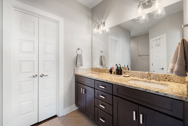 bathroom featuring parquet flooring and vanity