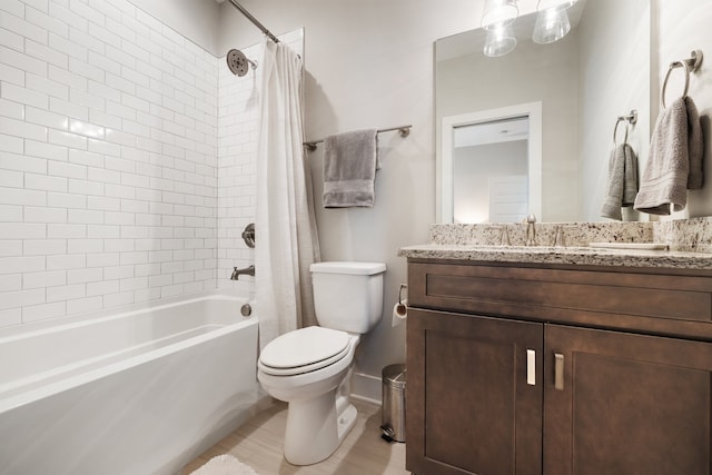 full bathroom featuring shower / bathtub combination with curtain, vanity, and toilet