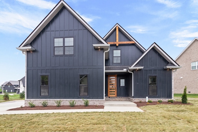 modern farmhouse style home with a front lawn