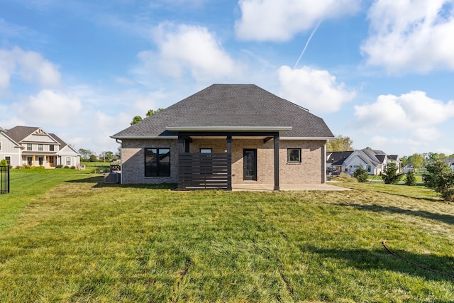 back of house featuring a yard and a patio area