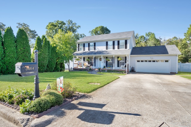 colonial home featuring a garage, a front lawn, and covered porch