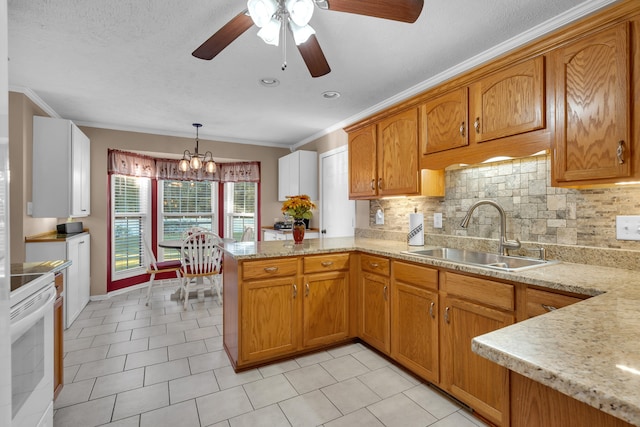 kitchen with hanging light fixtures, sink, tasteful backsplash, kitchen peninsula, and white range oven