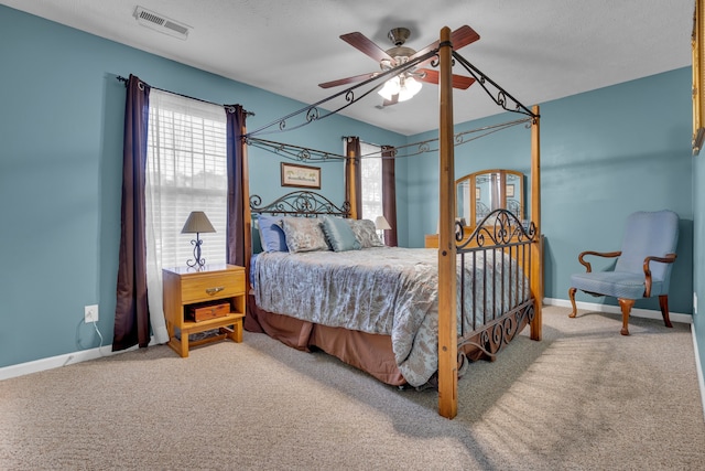 bedroom featuring ceiling fan, a textured ceiling, and carpet flooring