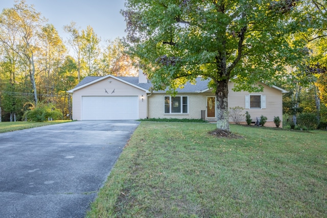 ranch-style home with a front yard and a garage