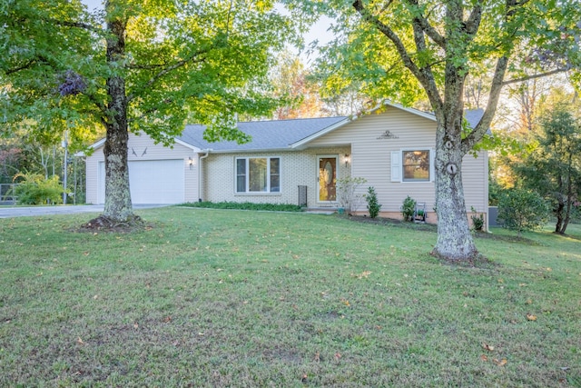 ranch-style house featuring a garage and a front lawn