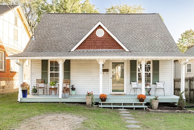 back of house featuring a yard and covered porch