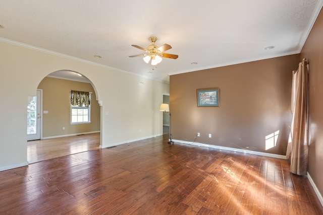 empty room with ornamental molding, hardwood / wood-style floors, and ceiling fan