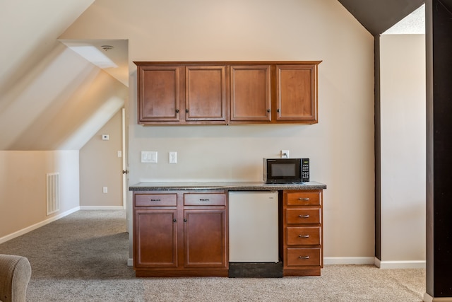 kitchen with light carpet, lofted ceiling, and white refrigerator