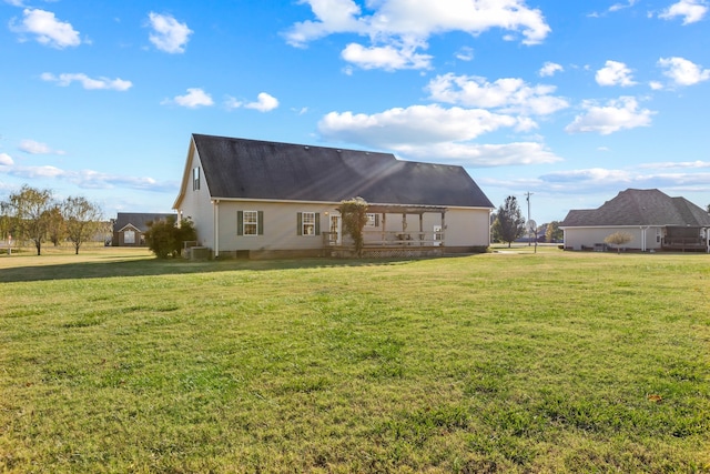 back of house featuring central AC and a lawn